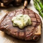 Perfectly cooked Air Fryer Filet Mignon with garlic butter, served on a plate.