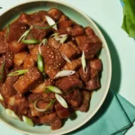 Deliciously grilled Korean pork belly served with kimchi and dipping sauce.